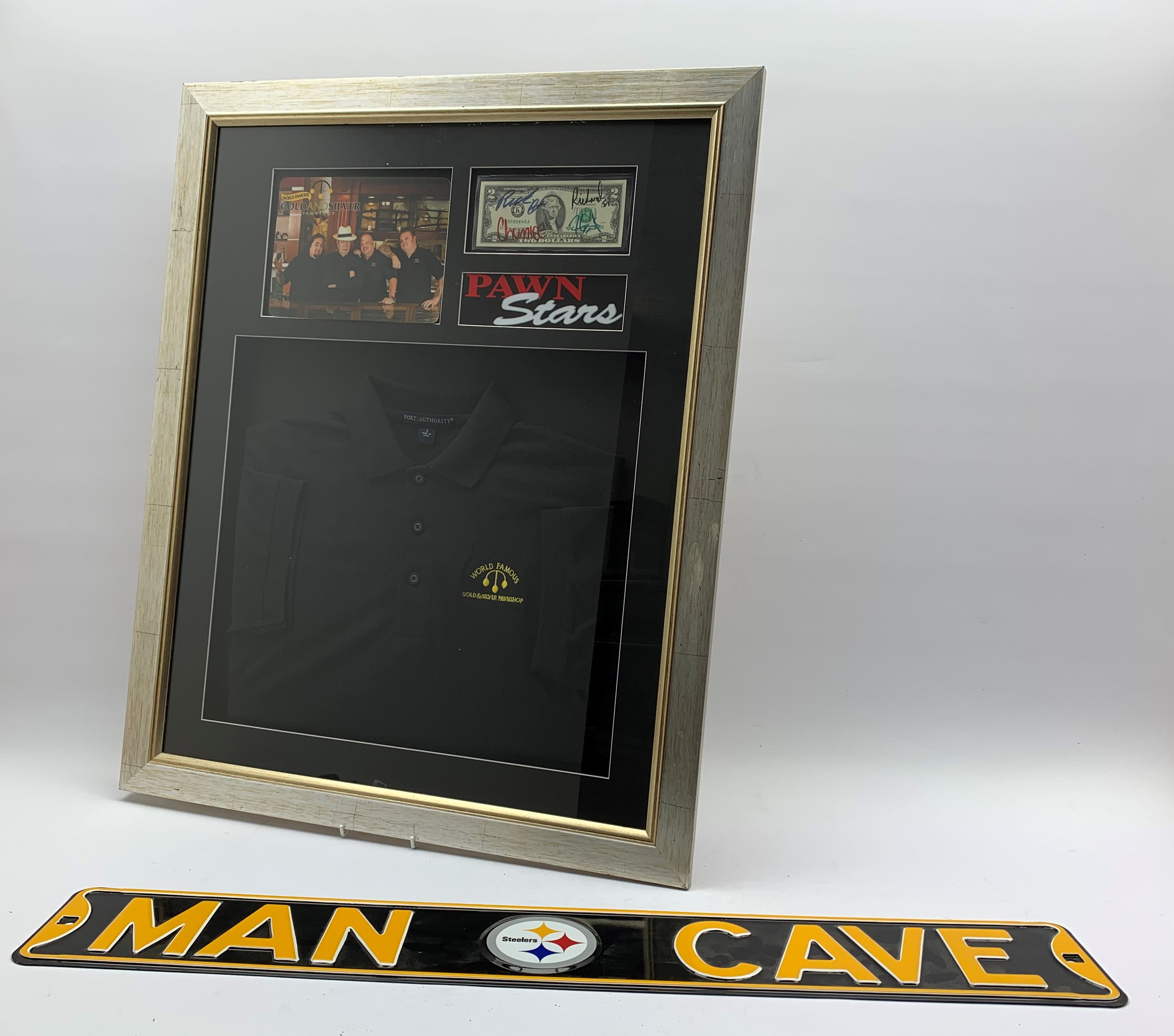 Framed memorabilia from the American TV show 'Pawn Stars' comprising a branded Polo shirt,
