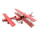 Ceiling hanging red painted model of a biplane,