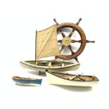 Decorative ships wheel, D63cm and three small models of rowing or fishing boats with oars,