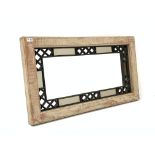 20th century oak framed wall mirror with geometric cast metal decoration,