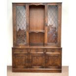 20th century Tudor design oak sectional display cabinet, led glazed doors enclosing shelves,