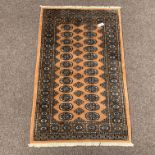 Persian design Bokhara yellow ground rug, repeating gul motif enclosed by double guarded border,