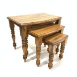 Hardwood nest of three tables, each with bow fronts raised on turned supports,