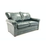 Contemporary two seat sofa, upholstered in green faux leather,