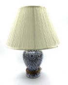 20th Century blue and white ceramic lamp with floral decoration and shade,