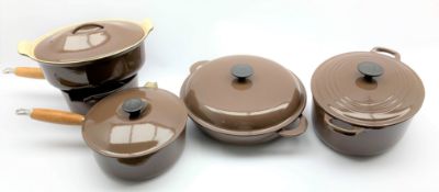 Set of five brown Le Creuset pots and pans