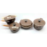 Set of five brown Le Creuset pots and pans