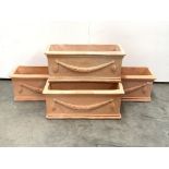 Set four trough shaped terracotta planters decorated with floral swags,