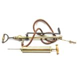 Crescent brass stirrup pump with cast iron bracket, and brass vets pump,