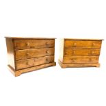 Pair of hardwood chests of three long drawers each, raised on shaped plinth base,