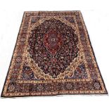 Persian Meshed blue ground carpet, with medallion and interlaced trailing foliate on blue field,