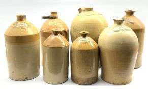 Seven stoneware flagons including large flagon of baluster form stamped 'G.