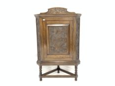 Victorian deign oak corner cupboard, with panelled floral scroll carved door enclosing two shelves,