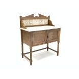 Edwardian oak washstand with raised tile back over white marble top,