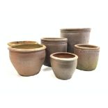 Three graduating salt glazed terracotta cylindrical planters,