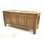 Late 18th century four panelled oak coffer with hinged lid and carved frieze,