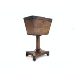 Regency mahogany tea poy of sarcophagus form, raised on octagonal pedestal and platform base,