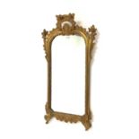 19th century upright wall mirror, the carved gilt wood frame having floral decoration,