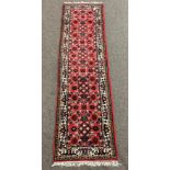 Indo Persian Hamadah red ground runner rug, decorated with all over floral design,