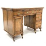 Late Victorian golden pine twin pedestal desk, skivered top over four drawers and a cupboard,