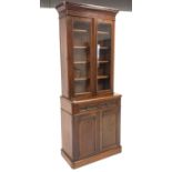 Victorian mahogany bookcase on cupboard, with projecting cornice over glazed doors,