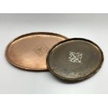 Hugh Wallis hammered copper tray, 39cm x 28cm and another similar with central pewter floral motif,