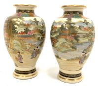 Pair of Japanese Satsuma baluster vases decorated with figures and landscapes and with seal mark to