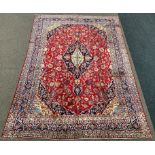 Persian Meshed ground carpet, floral medallion on red field surrounded by foliate,