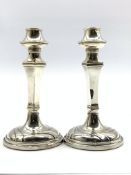 Pair of silver weighted candlesticks of Art Deco design with tapering stems H16cm Birmingham 1913