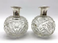 Pair moulded glass globe scent bottles with silver lids,