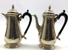 Pair of silver cafe au lait pots with domed covers and urn finials with ebonised handles H19cm