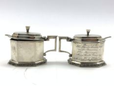 Pair of silver octagonal mustard pots of Art Deco design with blue glass liners and hinged covers