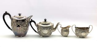 Late Victorian silver four piece tea set of oval form embossed with birds and flowers around a