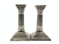 Pair of Edwardian silver candlesticks with reeded columns and stepped square bases H12cm Sheffield