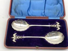 Pair of Edwardian silver serving spoons with caduceus terminals and scalloped edged bowls Sheffield