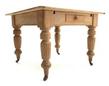Victorian pine square farmhouse dining table, with turned fluted supports raised on castors,