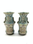 Pair of Victorian pottery vases of oval form decorated in cream,