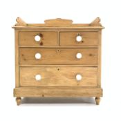 Victorian pine chest of two short and two long drawers, with three quarter galleried top,