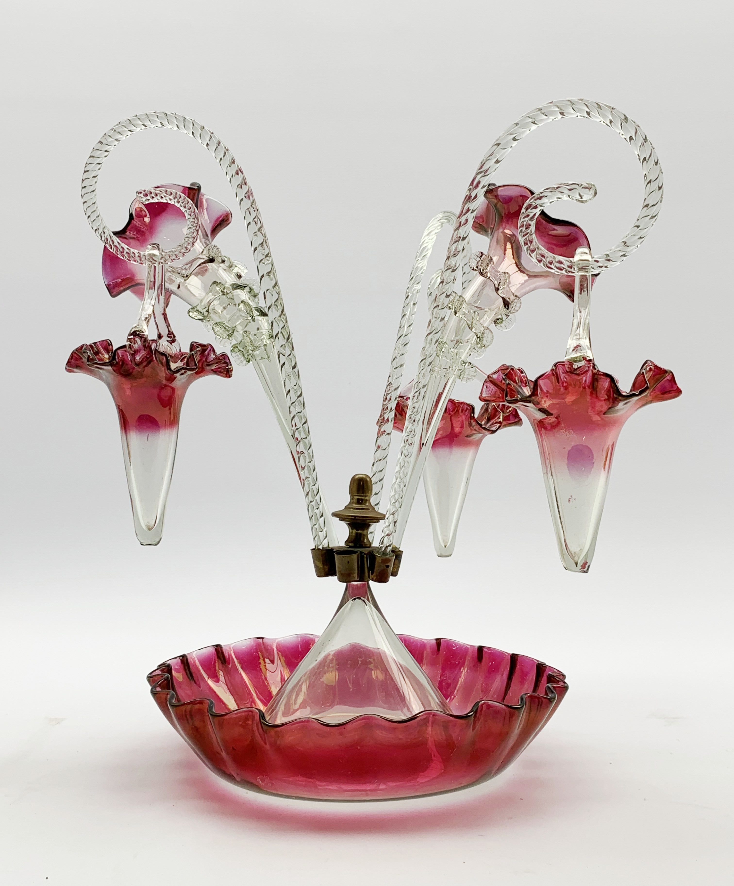 Victorian cranberry and clear glass epergne with trumpet shape vases and baskets on a crimped