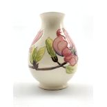 Moorcroft baluster vase decorated in the Pink Magnolia pattern on a cream ground H19cm