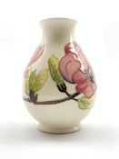 Moorcroft baluster vase decorated in the Pink Magnolia pattern on a cream ground H19cm