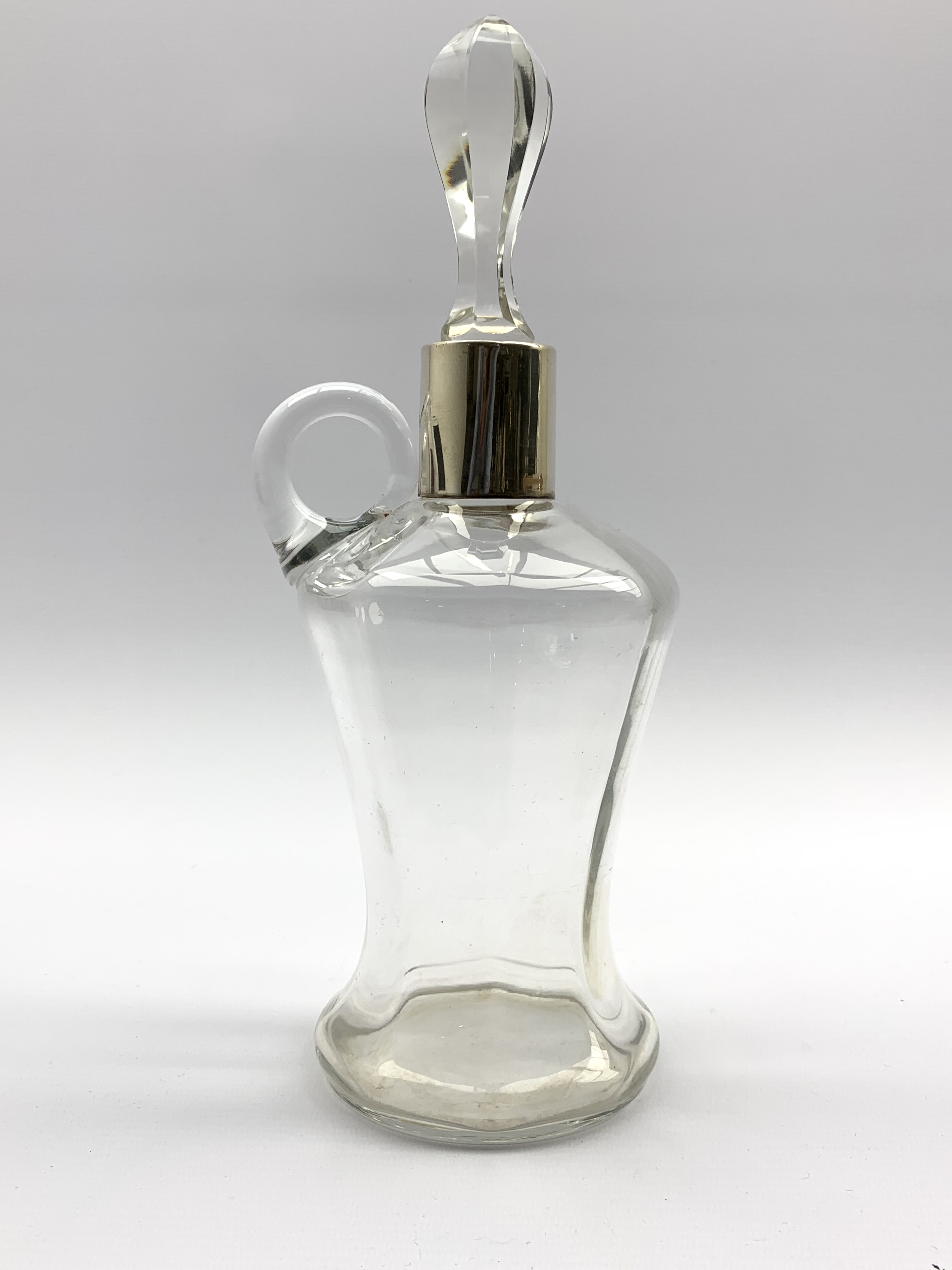 Glass whisky jug of panel sided waisted design with silver collar and associated stopper H28cm