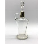 Glass whisky jug of panel sided waisted design with silver collar and associated stopper H28cm