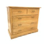 Modern light ash chest fitted with two short and three long drawers, raised on shaped plinth base,