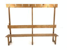 20th century slatted pine changing room bench with raised back fitted with hanging hooks, W221cm,