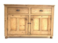 Victorian waxed pine sideboard, with two drawers above two panelled cupboards,