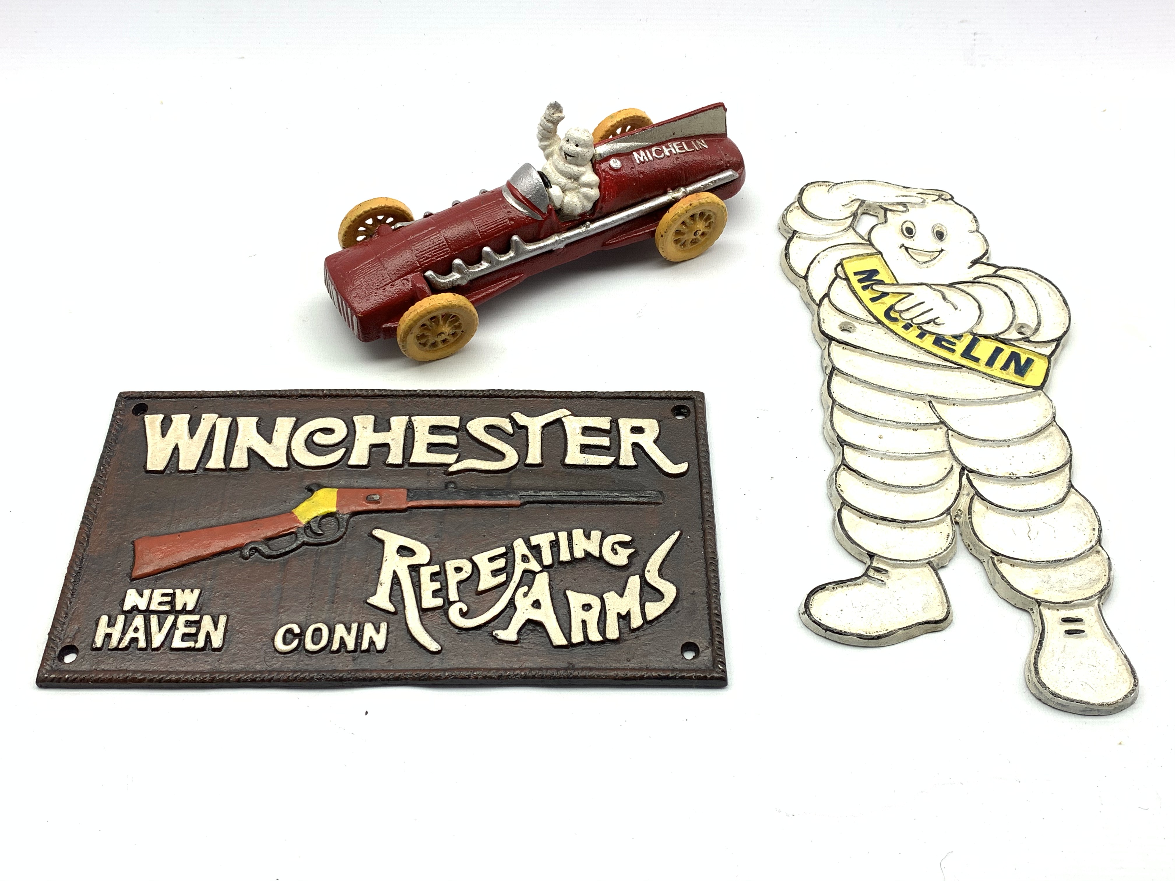 Reproduction Michelin Man racing car and wall plaque and a cast metal plaque reading 'Winchester,