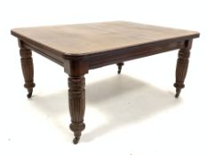Victorian mahogany extending dining table, with two leaves, raised on turned fluted supports,
