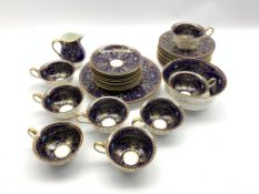 Early 20th century Wedgwood part tea service, white ground with Cobalt blue and gilded borders,