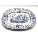 Early 19th Century blue and white meat plate transfer printed with the 'Ancient Ruins' pattern 54cm
